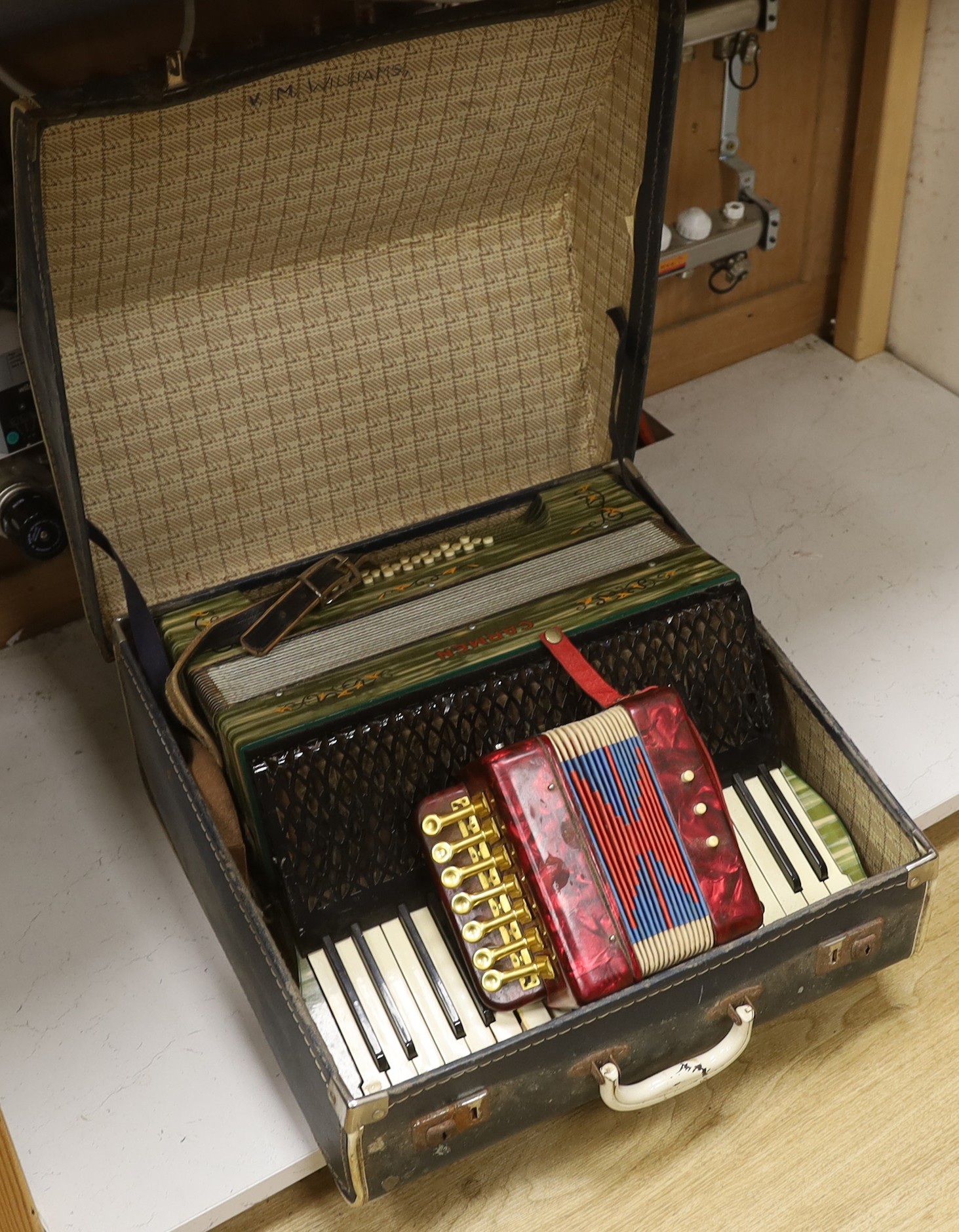 A cased Carmen piano accordion and another smaller keyed accordion (2)